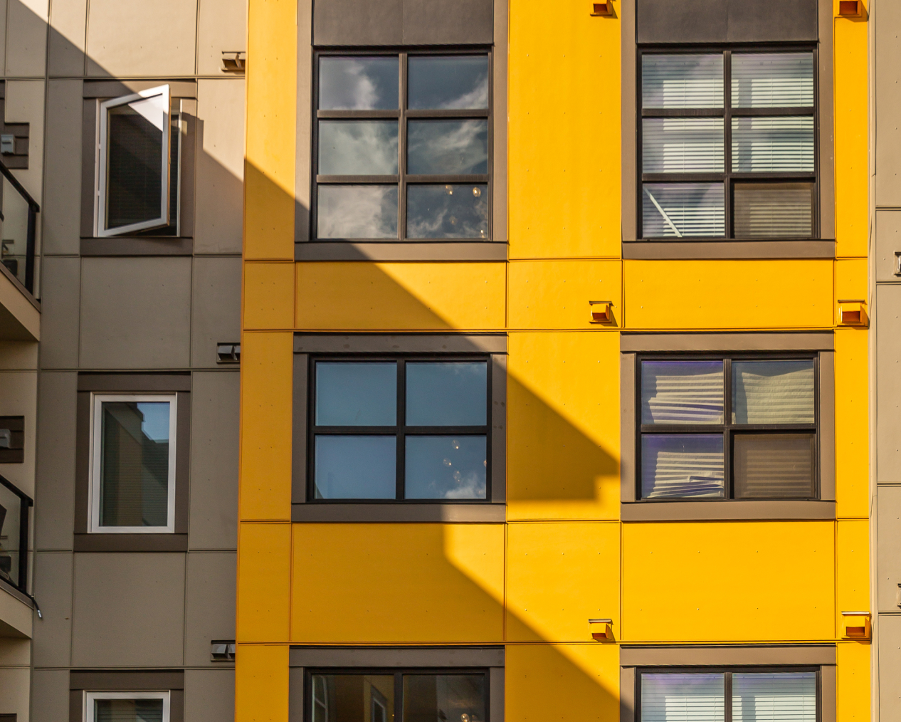 A yellow condo building with EasyTrim siding.