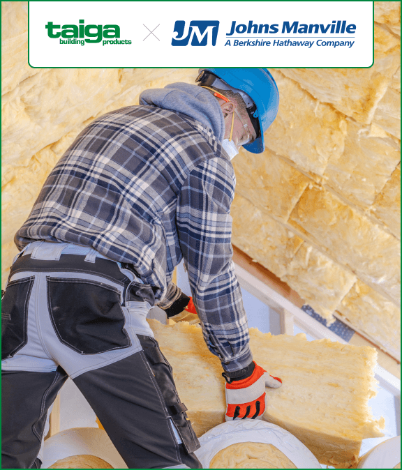 A worker in a plaid shirt, helmet, and gloves installs fiberglass insulation in an attic. Logos for Taiga Building Products and Johns Manville are visible.